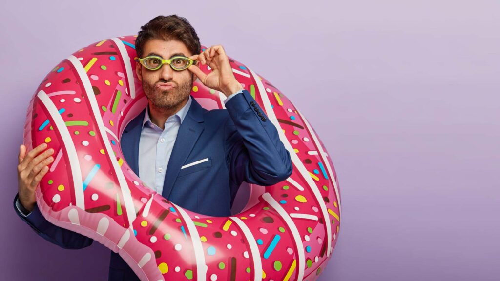 Man with donut-shaped blow-up flotation device illustrates the visualization step of Monroe’s Motivated Sequence in persuasive speech, helping the audience imagine positive outcomes in the five-step process and act.