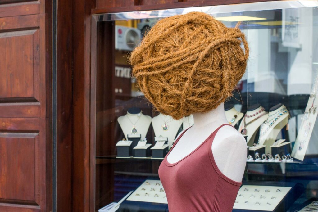 Mannequin with yarn ball head illustrates the attention step of Monroe’s Motivated Sequence in persuasive speeches, using a creative metaphor to motivate audience focus and spark action.